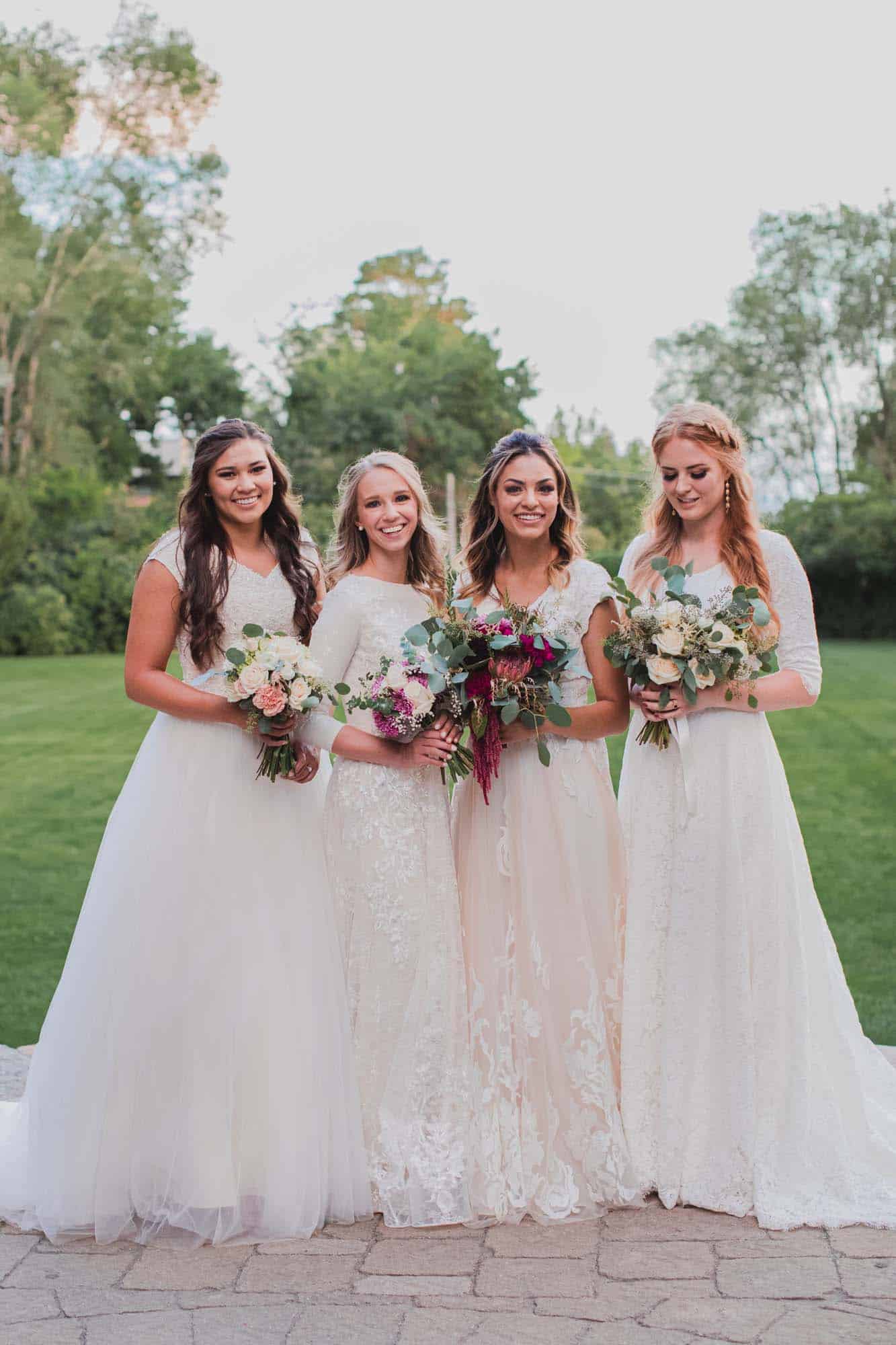 Bride's 4 flower girls wearing modest wedding dresses while holding bouquet of flowers